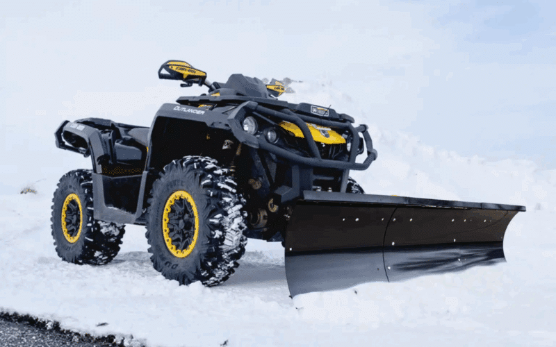 ATV with snow plow attached in snow