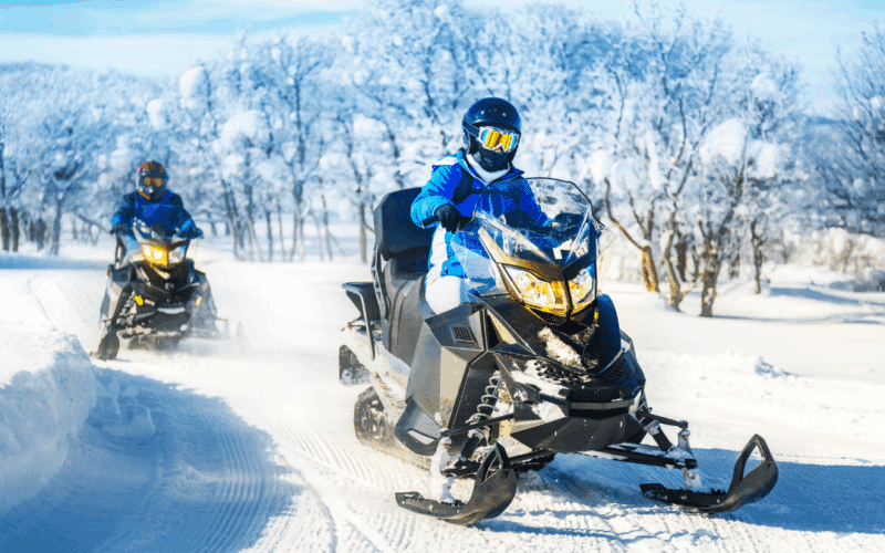 two snowmobile riders