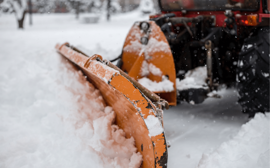 ATV snow plow pushing snow