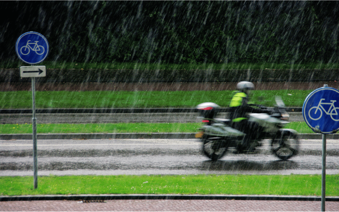 Person riding a motorcycle during a spring rain shower