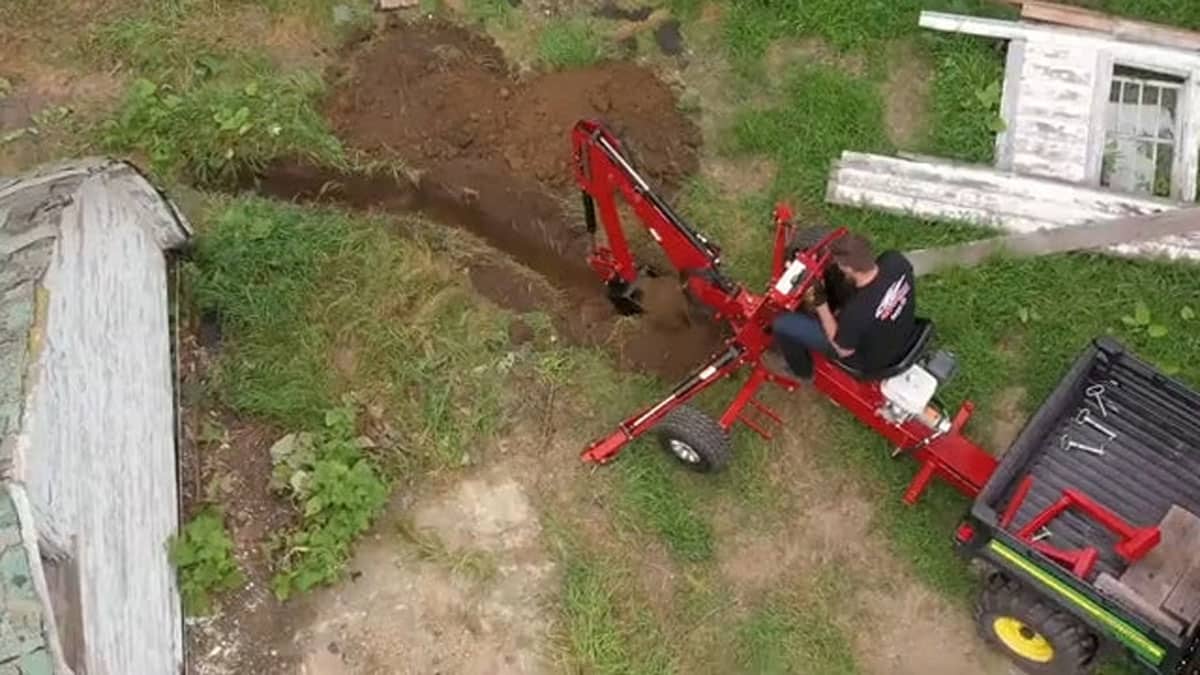 DirtMaster towable backhoe being towed behind a UTV